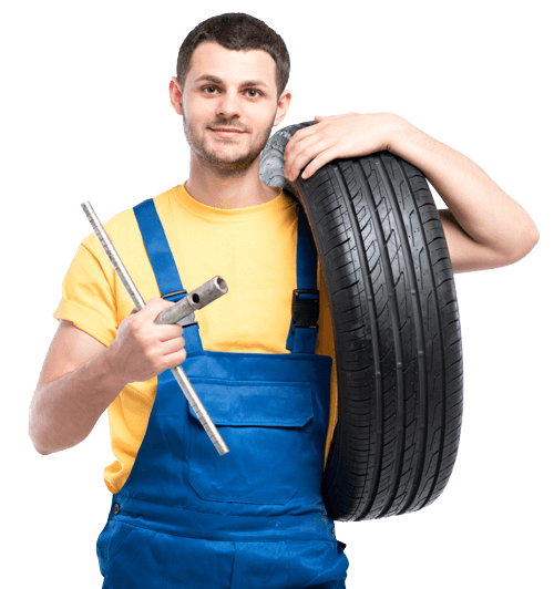 Leistungen im Überblick - Mitarbeiter der auf dem Weg ist zum Reifenwechsel mit guter Laune